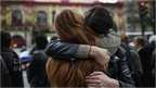 Parisians hug each other in support over the Paris attacks