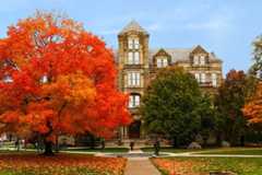Color photo of Case Western Reserve University’s Adelbert Hall with fall foliage on nearby trees