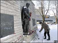 Man lays flower at Soviet war memorial, Tallinn
