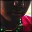 girl wearing green bead necklace [JULIE REMY/MSF]
