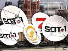 Logos of German cable/satellite TV stations on rooftop dishes 