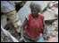 Woman in rubble in Port-au-Prince, Haiti (13 Jan 2009)