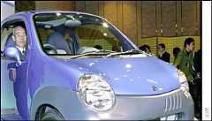 President of Japans car and motorcycle maker Suzuki Masao Toda (at the wheels) and his successor Hiroshi Tsuda (L) introduce its new small car Twin in Tokyo, 22 January 2003