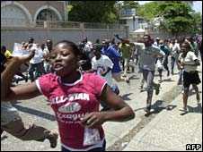 Haitians run through the streets during protests against the rising cost of living in Port-au-Prince on 8 April, 2008