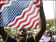 Kisumu residents wave a US flag in celebration of Barack Obama's victory in the US presidential race