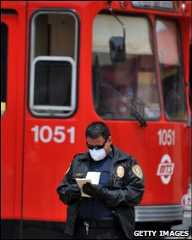 A US transport security officer wearing a mask near the border with Mexico