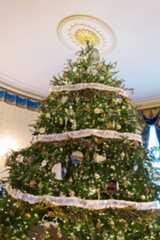 This year's iconic Blue Room Christmas Tree celebrates "We the People," as it is trimmed with ribbon garland featuring the Preamble to the United States Constitution.