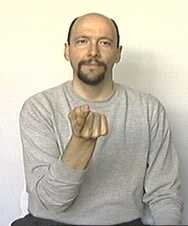 end of 'I tell you'. the dominant hand with index finger extended, palm up, is pointing to a point in front of the signer.