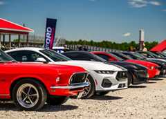 A lineup of Ford Mustang's from various years