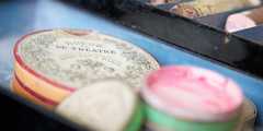 Some circular make-up containers in a tray.