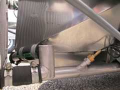 Coolant and oil return lines route underneath the chassis rather than through it.