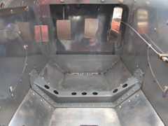 A stiff steel brace helps transfer suspension loads across the floor panel.