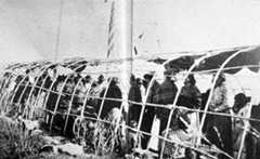 Midewiwin, or Grand Medicine Society, religious ceremony being held in the special lodge known as the Midewigan.