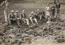 Villagers sit around the crater from the first bomb to land in the village on July 26, 1940 (Image: Nazeing History Workshop)