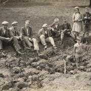 Villagers sit around the crater from the first bomb to land in the village on July 26, 1940 (Image: Nazeing History Workshop)