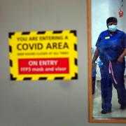 A nurse walking through a Covid ward