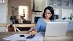 Woman sitting at table with computer