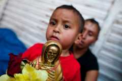 On the first day of every month, devotees to Santa Muerte fill the streets of Tepito, holding figurines of Holy Death and praying at the altar established in a window at the home of Enriqueta Romero.