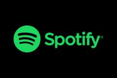 The green Spotify logo features three curved black lines inside a circle next to the word Spotify in lowercase letters.