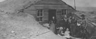 Family in front of dugout, Ford County, Kansas