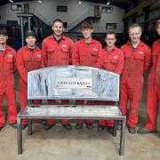 Young apprentices at WEC Group with bench made from surrendered knives