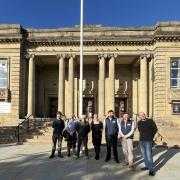 Hyndburn Leisure chief executive Lyndsey Sims flanked by representatives from Rosslee Construction in front of Mercer Hall