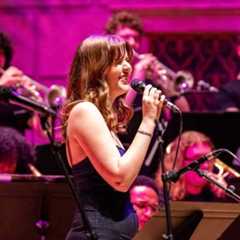 A group of musicians playing brass instruments during a concert at the Eastman School of Music, University of Rochester.