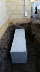 Plastic soakwells being installed-322x572