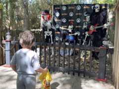 kid watching animatronic skeleton band