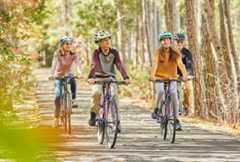 A family riding their bikes together in Williamsburg, Virginia.