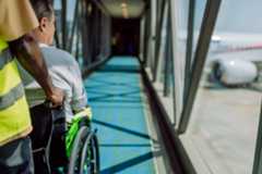 Person being pushed in wheelchair to get onto plane