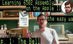 A bearded, bespectacled man in front of an Apple II computer with the superimposed text "Learning 6502 Assembly on the Apple II the easy way Ep. 1: The Bell"