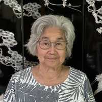 Photo of a Chinese American woman with gray hair and glasses