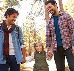 Two men hand in hand with young girl