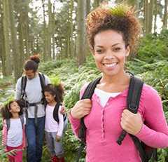 Young family hiking in woods