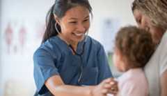 medical A photo of a female medical professional listing to a child's chest.