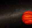 A Strange Brown Dwarf Gets Stranger A glowing orange sphere set against a background image of the Milky Way's disk of stars.