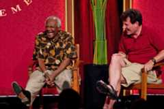 Archbishop Desmond Tutu enjoys a light moment with journalist Nicholas Kristof during their panel discussion. 