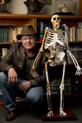 Professor Lee Berger with the reconstructed skeleton of Australopithecus sediba. (Photo by Brett Eloff, courtesy of Lee Berger)