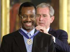 President George W. Bush presents a Presidential Medal of Freedom to Dr. Benjamin S. Carson for his work with neurological disorders during an East Room ceremony June 19, 2008 at the White House in Washington, D.C. The medal is the nation's highest civilian award. (Photo by Alex Wong/Getty Images)