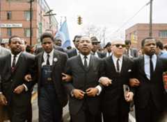 In 1965, John Lewis (far right) with Dr. Martin Luther King, Jr. (center) leads a march in Alabama from Selma to Montgomery, Alabama to protest the denial of voting rights to African Americans. (© Steve Schapiro/Corbis)