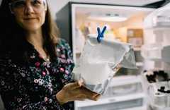 ARS scientist holding a bag of powdered casein