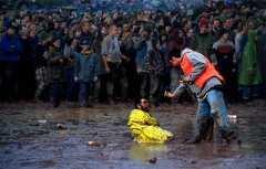 A festival-goer defeated by the mud