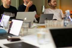 A team of developers work at their laptops at JAMS 2018