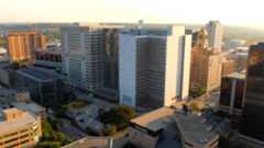 Drone footage sweeping over Mayo Clinic’s downtown Rochester campus during sunrise, emphasizing the size and modern architecture of the facility.