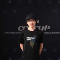 A person standing in front of a black backdrop