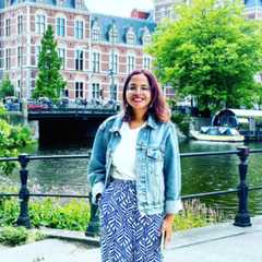 A person standing outside in front of a body of water