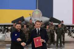 French President Emmanuel Macron and Ukrainian President Volodymyr Zelenskiy shake hands after signing an agreement at the Villacoublay air base near Paris, France, November 17, 2025.