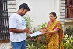 A BLO collects an enumeration form from a woman in Nabadwip.