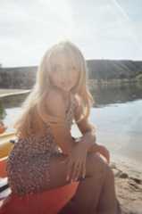 Image may contain Face Head Person Photography Portrait Blonde Hair Clothing Swimwear Adult Sitting and Dress